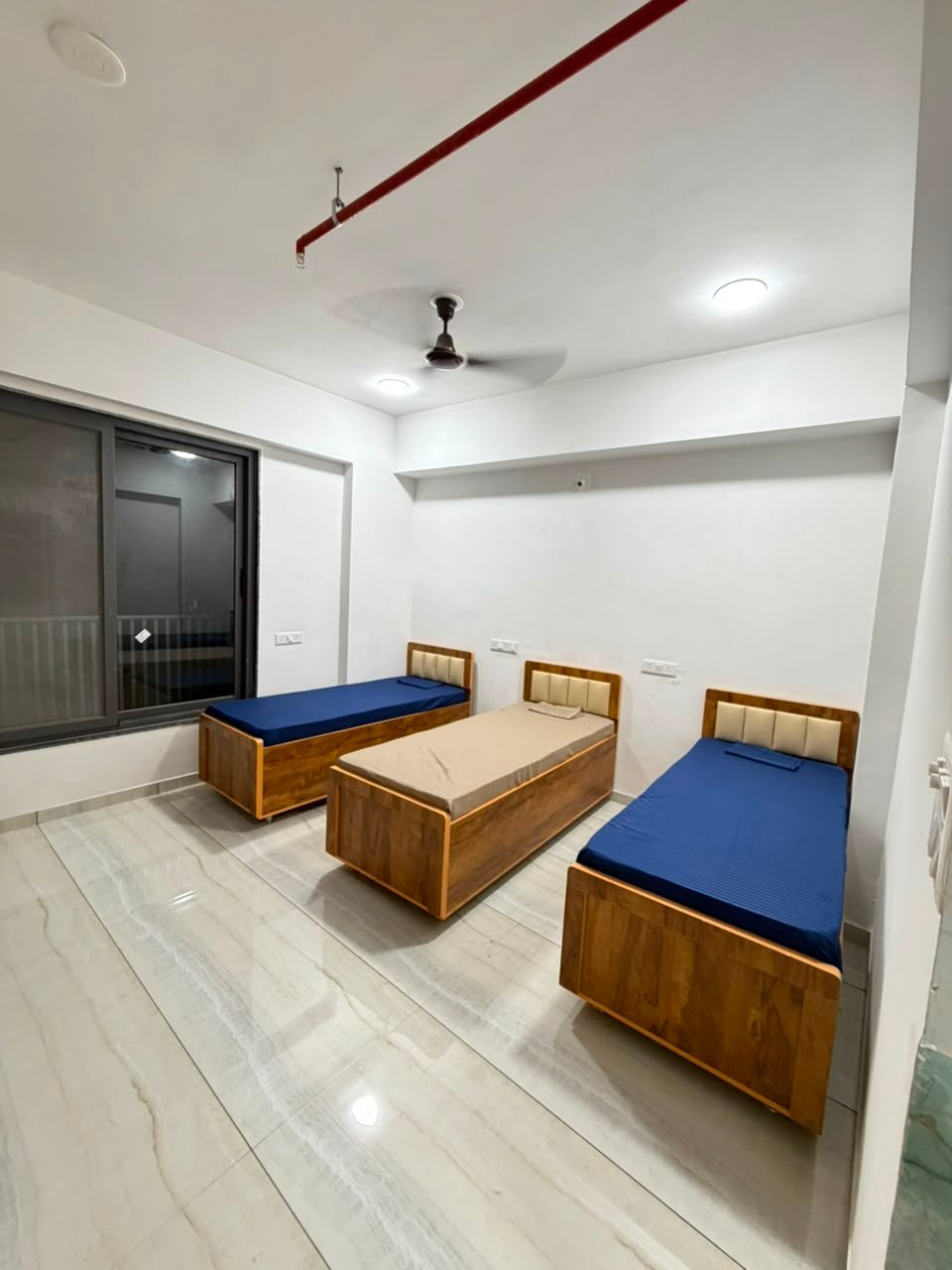 Furnished bedroom at Whitestone PG
